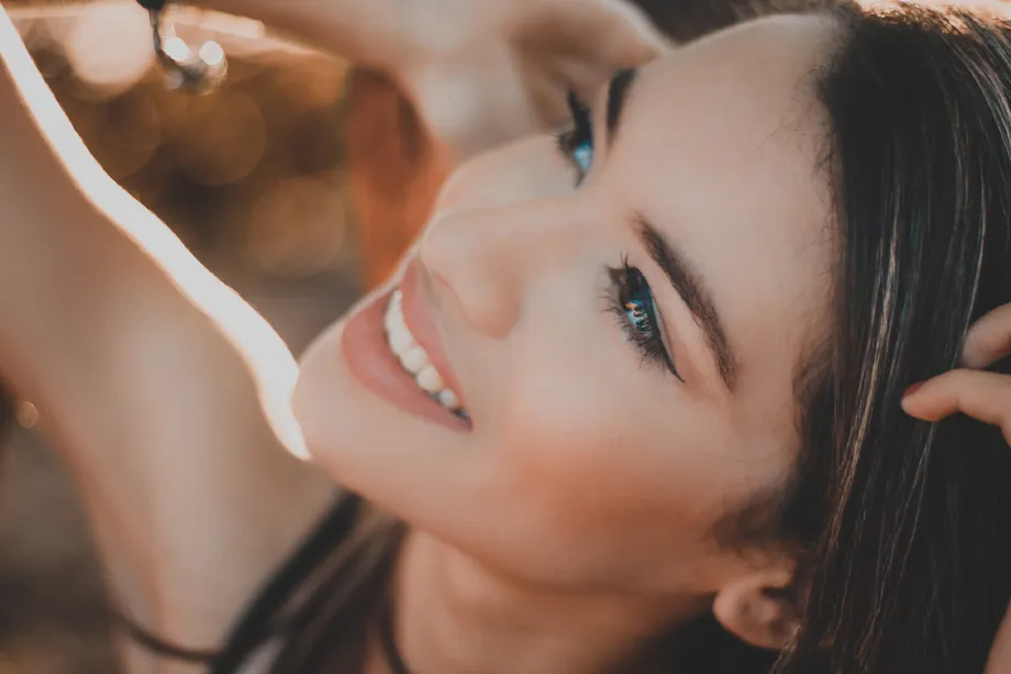 smiling woman with black hair and red lipstick